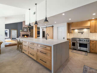 Experience luxury in this stunning kitchen featuring a large marble island with ample storage and seating.