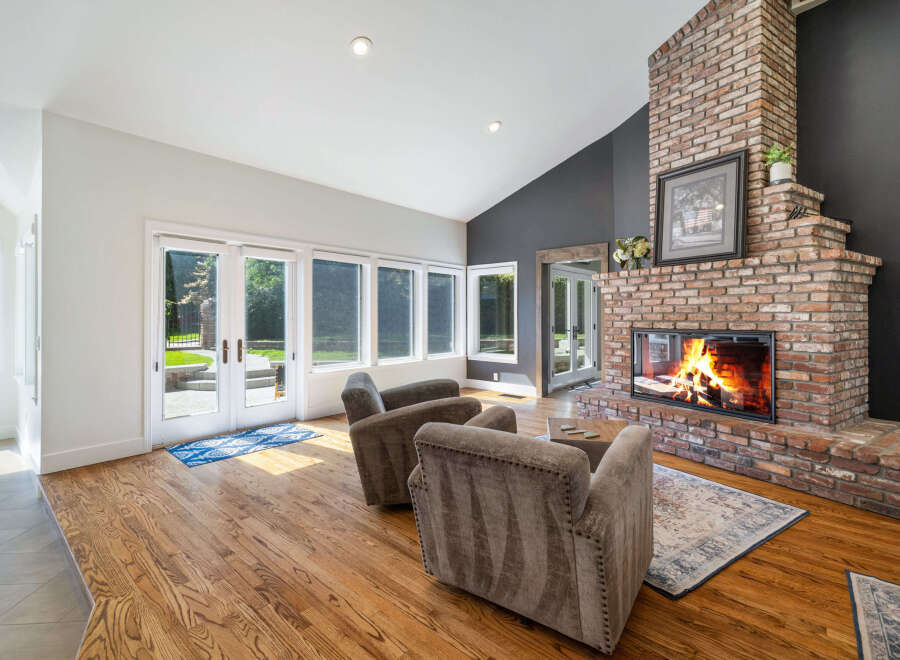 Experience cozy evenings by the stunning brick fireplace in this inviting living room.