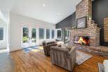 Experience cozy evenings by the stunning brick fireplace in this inviting living room.