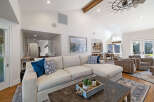Experience luxurious living in this spacious great room, featuring a large sectional sofa and comfortable armchairs perfect for relaxation.