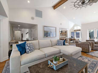 Experience luxurious living in this spacious great room, featuring a large sectional sofa and comfortable armchairs perfect for relaxation.