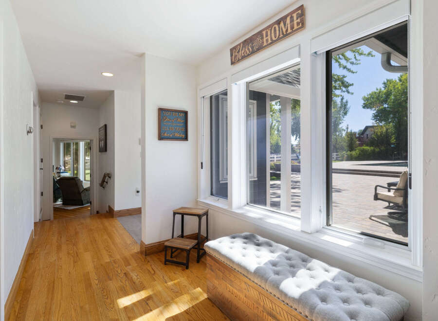 Step into this charming entryway featuring warm hardwood floors and a welcoming ambiance.