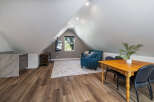 Discover this charming attic space, perfect for a home office or guest suite.