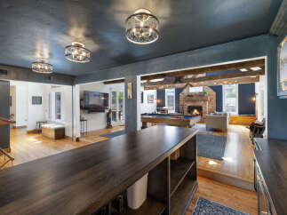 Experience ultimate entertainment in this stunning home featuring a spacious game room with a pool table and a cozy living area with a fireplace.