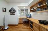 This home office features a built-in wooden desk and shelving unit, perfect for organizing your work essentials.