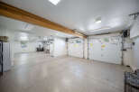 This spacious garage offers ample parking and storage with its multi-car capacity and high ceilings.