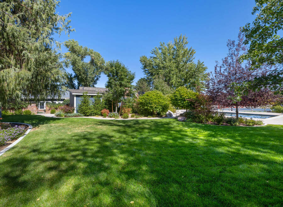 This stunning property boasts a beautifully manicured lawn, perfect for outdoor activities and relaxation.