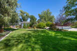 This stunning property boasts a beautifully manicured lawn, perfect for outdoor activities and relaxation.