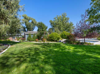 This stunning property boasts a beautifully manicured lawn, perfect for outdoor activities and relaxation.