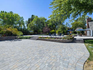 Experience outdoor living at its finest with this expansive paver patio, perfect for entertaining.