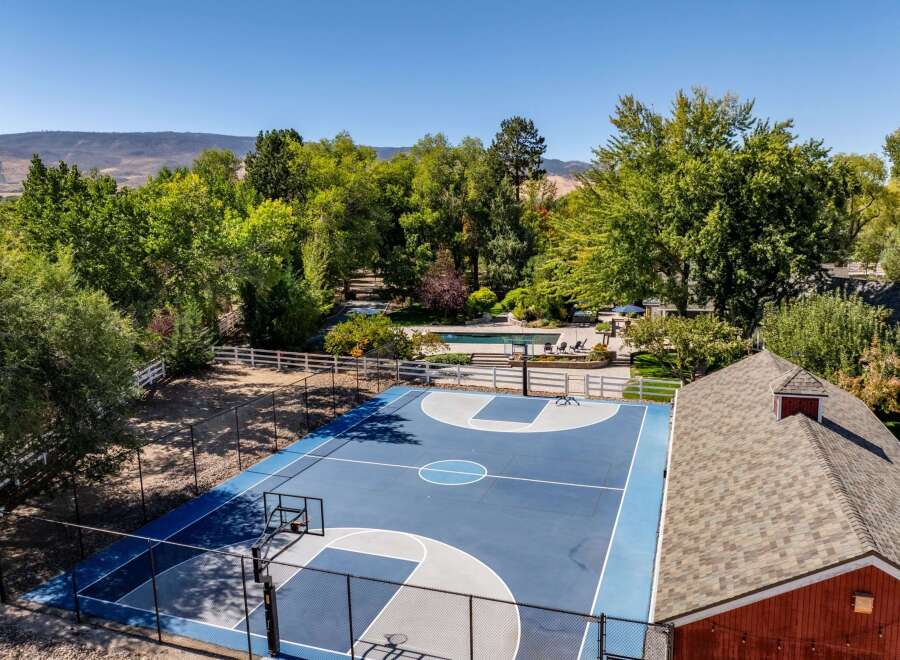 Enjoy outdoor recreation with a private basketball court and a sparkling swimming pool, perfect for family fun and entertaining.