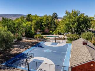 Enjoy outdoor recreation with a private basketball court and a sparkling swimming pool, perfect for family fun and entertaining.