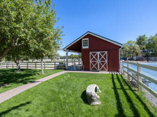 Discover this charming red barn, perfect for equestrian enthusiasts or as a versatile storage space.