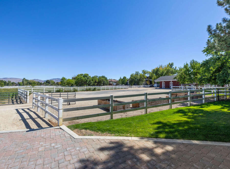 Experience equestrian living at its finest with this expansive property featuring a professional riding arena and multiple fenced pastures.