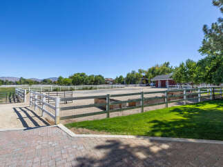 Experience equestrian living at its finest with this expansive property featuring a professional riding arena and multiple fenced pastures.
