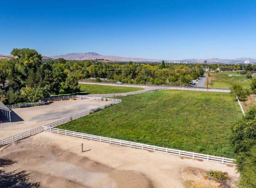 Discover this expansive property featuring a charming red barn and a spacious riding arena, perfect for equestrian enthusiasts.
