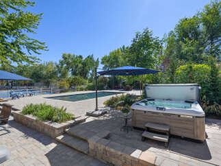 Experience ultimate relaxation in this backyard oasis, featuring a sparkling swimming pool and a luxurious hot tub perfect for unwinding.