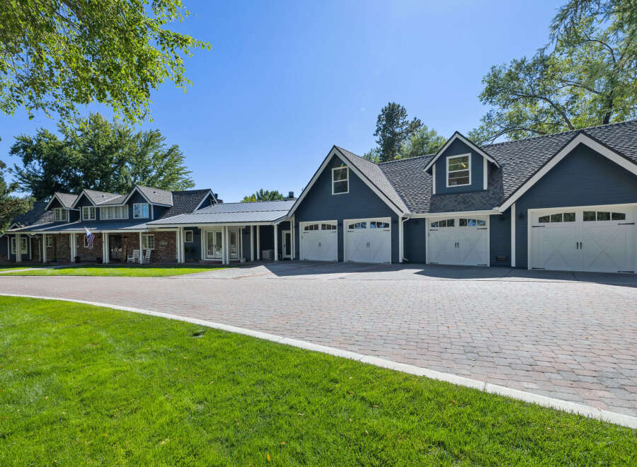 This stunning property boasts a spacious multi-car garage with elegant white doors, perfect for car enthusiasts or large families.