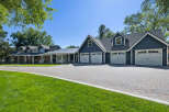 This stunning property boasts a spacious multi-car garage with elegant white doors, perfect for car enthusiasts or large families.