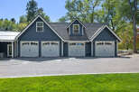 This stunning property features a spacious 4-car garage with elegant white doors and charming architectural details.