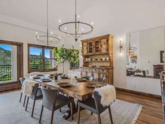 Experience elegant dining with this stunning wooden table, perfectly set for intimate gatherings.