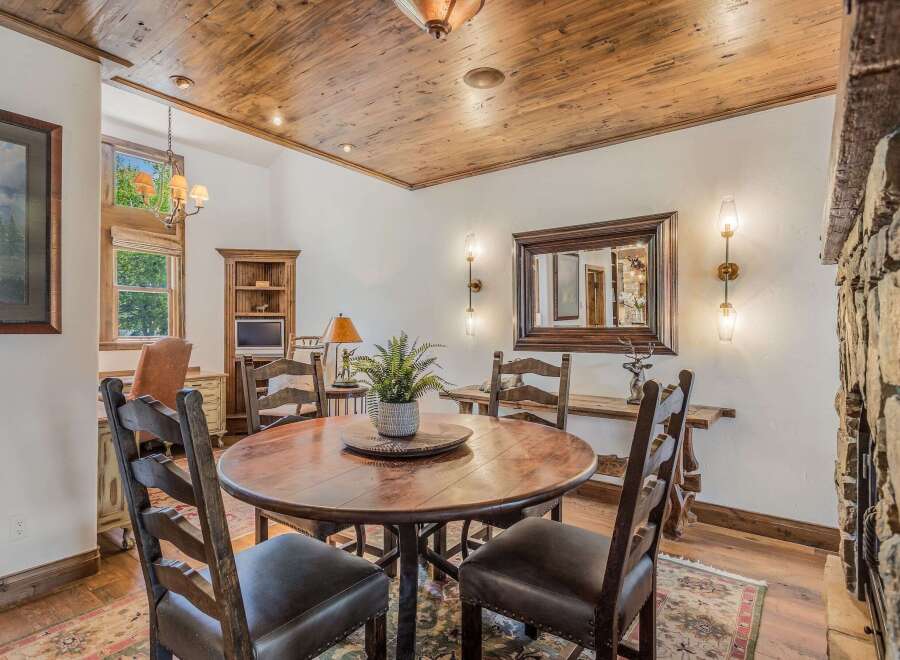 Experience rustic charm in this inviting dining area, featuring a substantial wooden table perfect for gatherings.