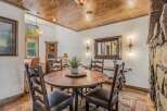 Experience rustic charm in this inviting dining area, featuring a substantial wooden table perfect for gatherings.