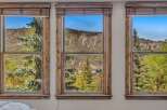 Experience breathtaking mountain views from this stunning property, featuring large windows that frame the picturesque landscape.