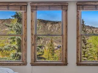 Experience breathtaking mountain views from this stunning property, featuring large windows that frame the picturesque landscape.