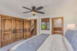 Experience rustic luxury in this charming bedroom featuring a plush king-sized bed adorned with a textured throw.
