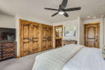 Experience rustic elegance in this master bedroom, featuring a luxurious king-sized bed adorned with a textured quilt.