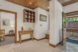Step into this charming entryway featuring a rustic wooden ceiling and a decorative shelf.