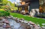 Experience luxury outdoor living with this stunning property featuring a modern home design seamlessly integrated with nature.