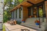 Experience modern living with this stunning home featuring a sleek exterior of wood and gray paneling.