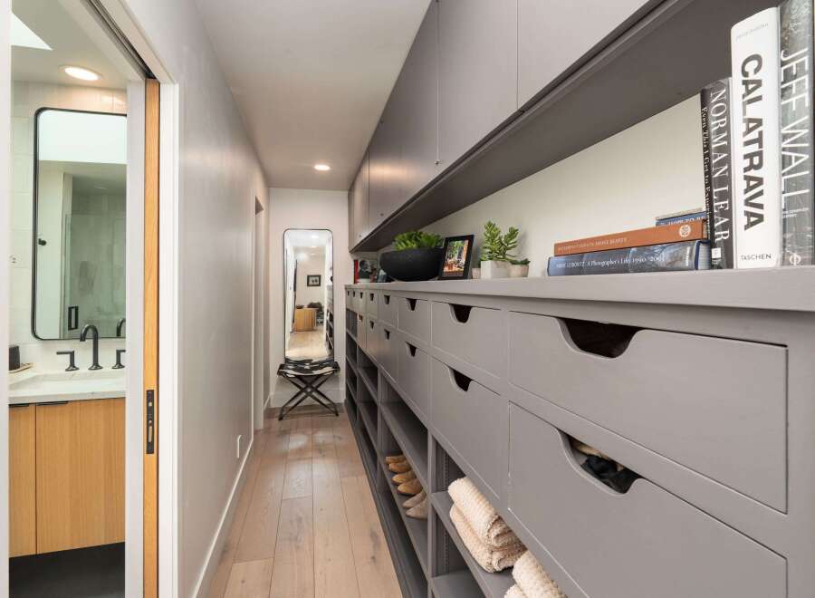 Discover a sophisticated walk-in closet and ensuite bathroom, perfect for modern living.