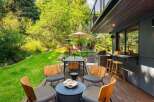 Enjoy outdoor living at its finest on this expansive deck, complete with a dining area, grill station, and bar seating.