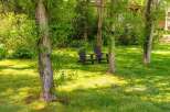 Enjoy the serene beauty of this lush green backyard, perfect for relaxation and outdoor living.