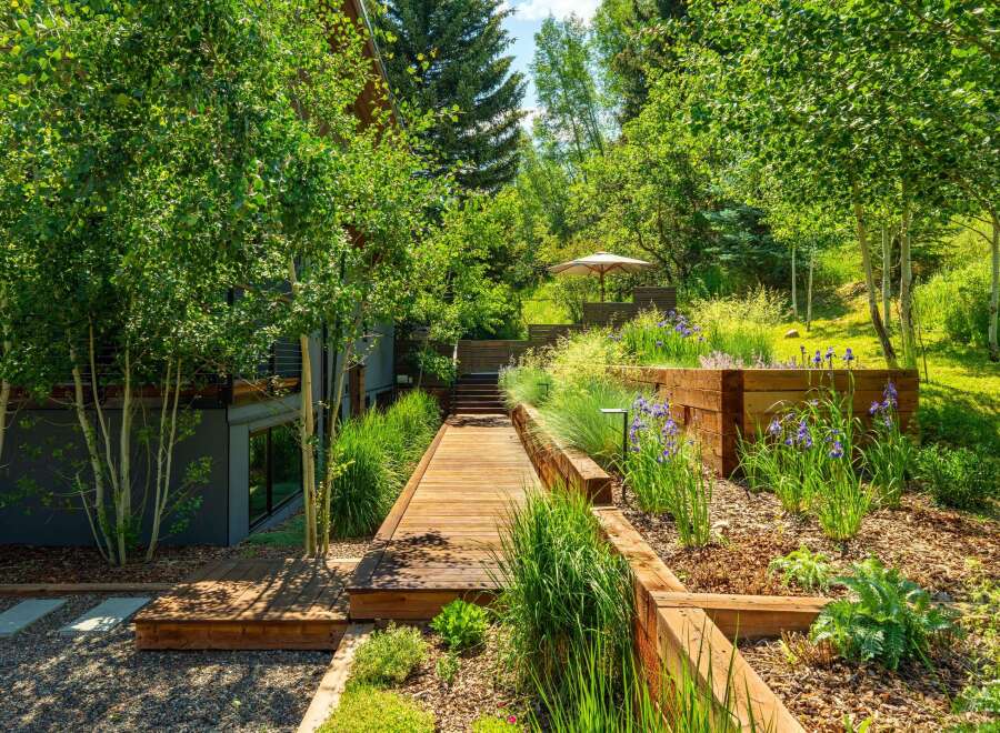 Experience seamless indoor-outdoor living with this stunning property, featuring a modern architectural design integrated with lush natural landscaping.