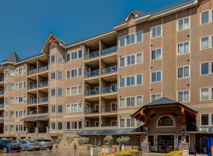 Discover modern living in this stunning apartment building, featuring spacious balconies with glass railings perfect for enjoying the outdoors.