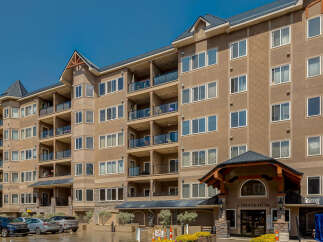 Discover modern living in this stunning apartment building, featuring spacious balconies with glass railings perfect for enjoying the outdoors.