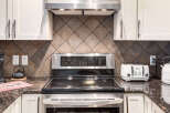 Experience modern convenience in this kitchen, featuring a sleek LG electric range with a digital display and a stylish white toaster.