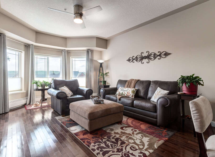 Step into this inviting living room, featuring plush leather seating and a large ottoman perfect for relaxation.