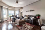Step into this inviting living room, featuring plush leather seating and a large ottoman perfect for relaxation.