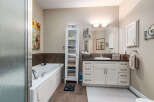 Indulge in relaxation in this spacious bathroom, featuring a deep soaking tub perfect for unwinding after a long day.