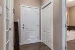 Step into this welcoming entryway featuring a classic white door with elegant trim and a matching closet door.