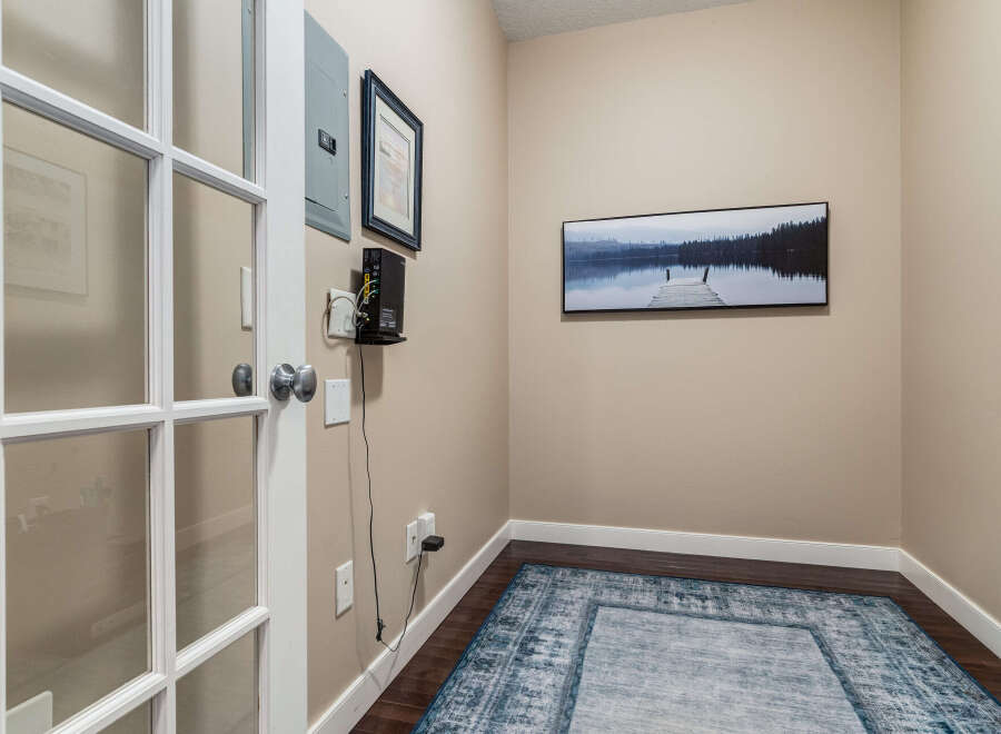Step into this inviting space featuring elegant French doors that open to a well-appointed room.