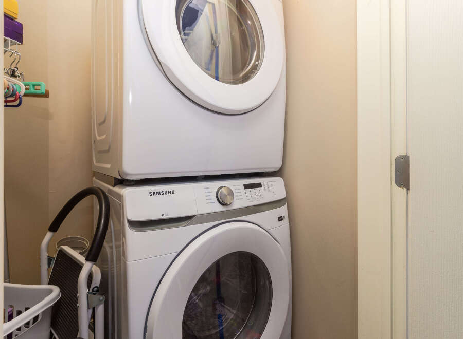 Discover the convenience of this stacked Samsung washer and dryer, perfect for optimizing space in your laundry area.