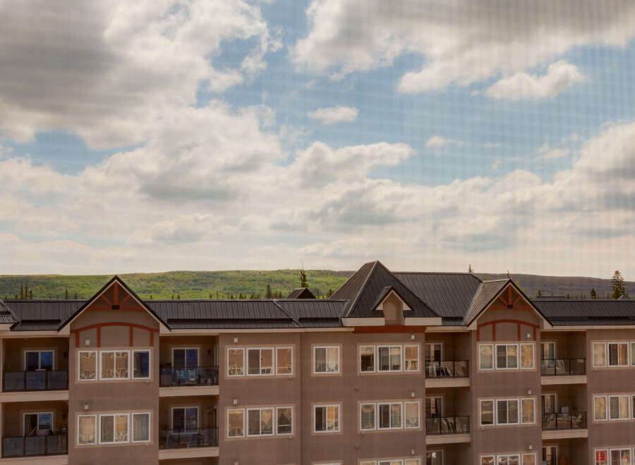 Experience modern living in this stunning multi-story apartment building, featuring spacious balconies and large windows that invite natural light.