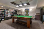 Enjoy leisure time in this well-appointed game room featuring a classic pool table perfect for friendly competitions.