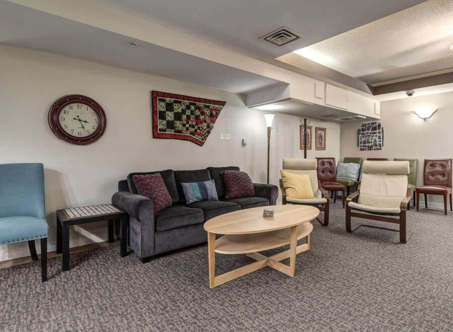 This inviting living space features a comfortable dark gray sofa adorned with decorative pillows, perfect for relaxation.